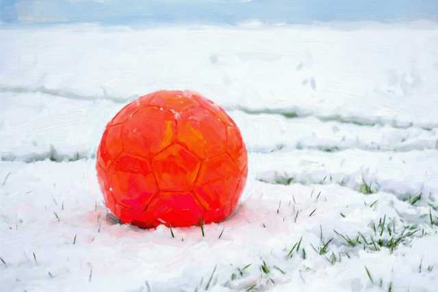 red-soccer-ball-on-snow