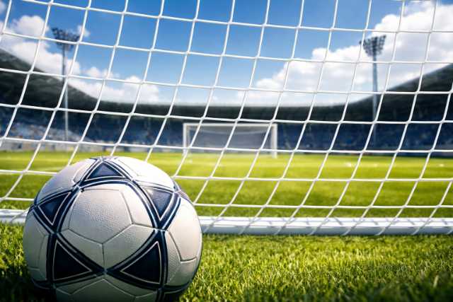 soccer-ball-in-front-of-goal-net-day
