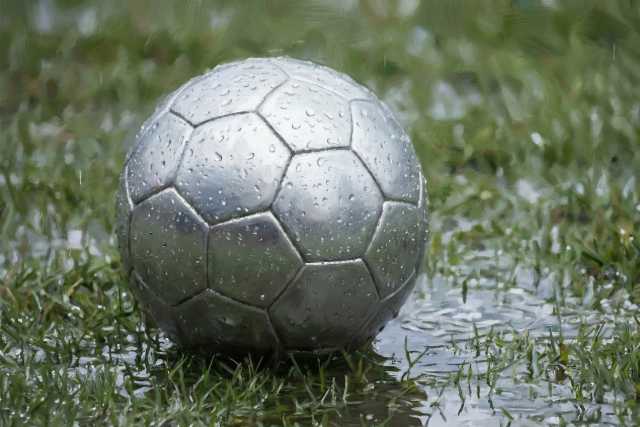 soccer-ball-in-puddle-on-wet-pitch